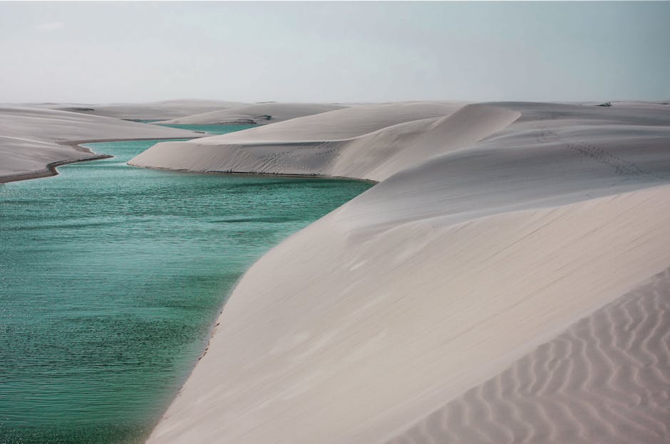 Desert sand dunes and clear river