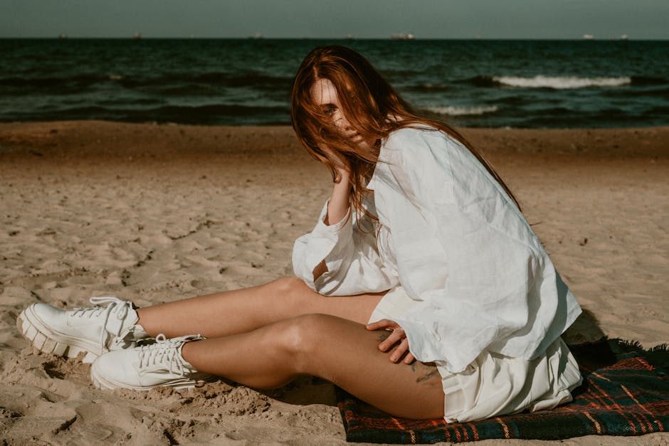 woman relaxing in minimalist casual outfit on beach