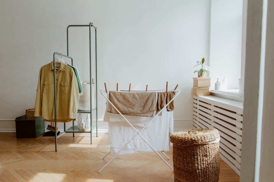 person organizing clothes on rack in bright sunny room