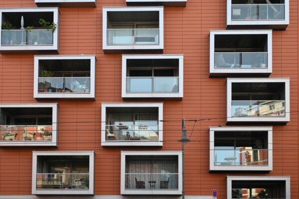 Stacked moving boxes in a modern city apartment with a skyline view.
