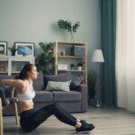 Woman performing bodyweight squats in a bright living room, illustrating home workout simplicity for beginners.