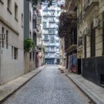 A bustling street scene in Buenos Aires, Argentina, with classic European-style architecture and local activity, suggesting a pre-Patagonia stopover.