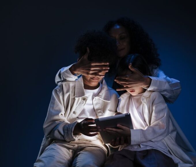 A parent and child looking at a tablet together, with the parent gently guiding the child's interaction, symbolizing digital safety.