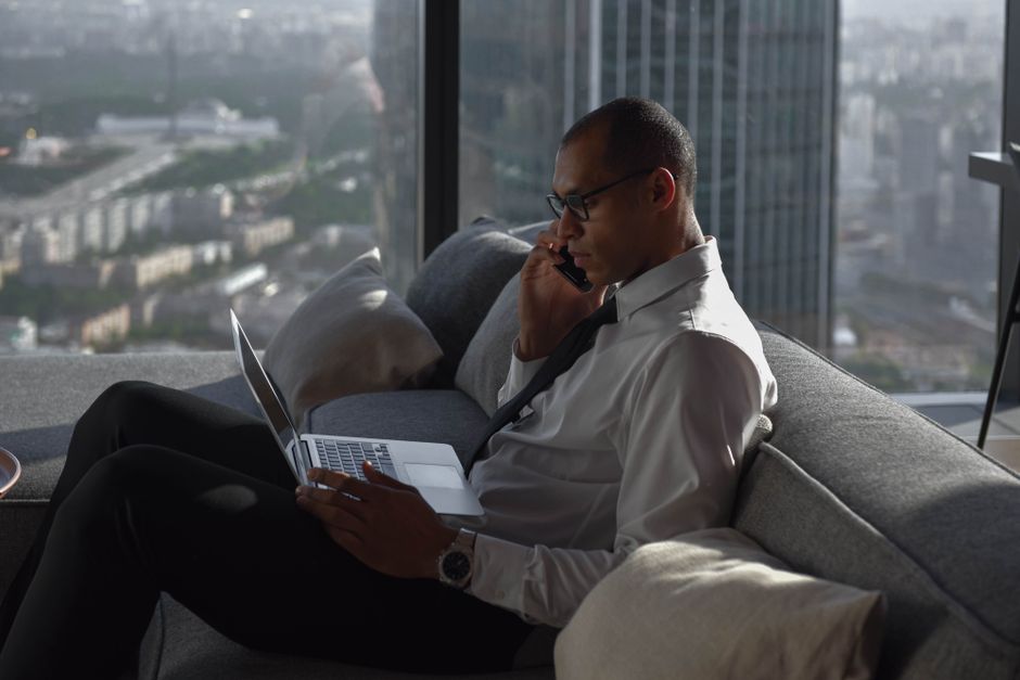 A dynamic city skyline in the background with a person looking determined while writing in a notebook, representing focused work amidst urban life.
