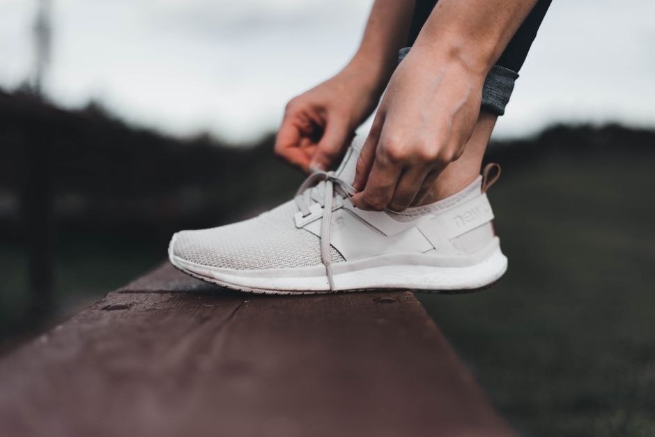 Close-up of a foot inside a shoe, highlighting the arch support and cushioning of the insole, essential for comfortable shoes for foot and back health.