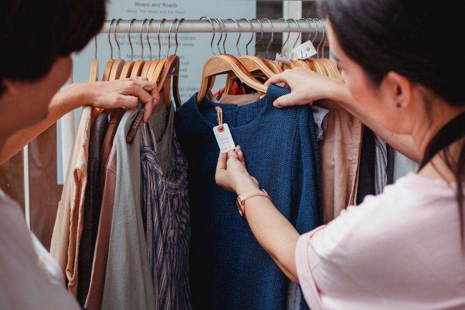 A close-up of a clothing rack filled with garments, many featuring 'Sale' or 'Final Sale' tags, hinting at clearance pricing.