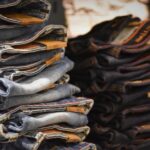A large pile of discarded, low-quality fast fashion clothing items, symbolizing waste and poor value.