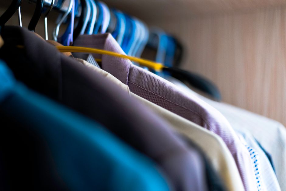 An organized closet with a mix of clothes and accessories, representing a well-curated, thoughtful wardrobe.