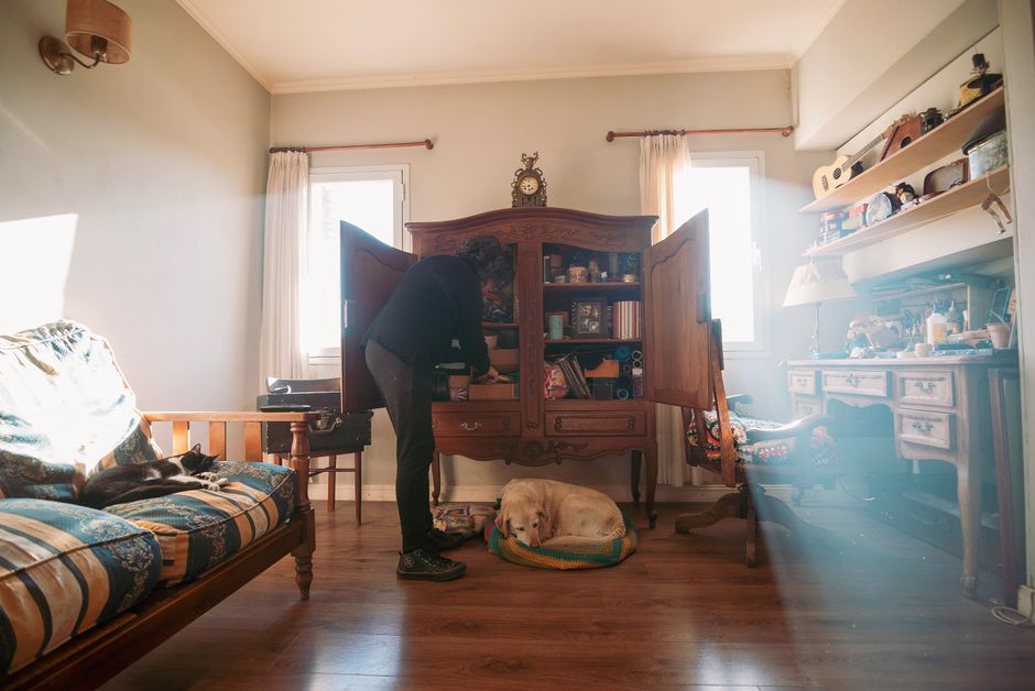A cozy living room bathed in natural light, with a person reading a book on a comfortable sofa, signifying relaxation after travel.