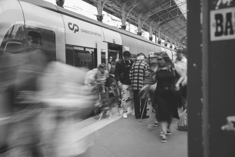 A bustling train station platform packed with travelers carrying luggage, indicating high demand during a public holiday in Europe.