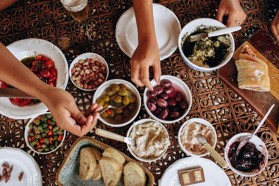 An array of colorful and varied tapas dishes laid out on a table, representing the affordable and diverse dining in Barcelona.