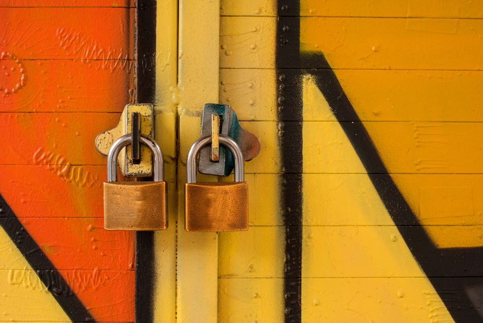 A glowing digital padlock icon superimposed over a blurred background of a laptop screen displaying meeting notes, symbolizing data security and privacy in AI transcription.
