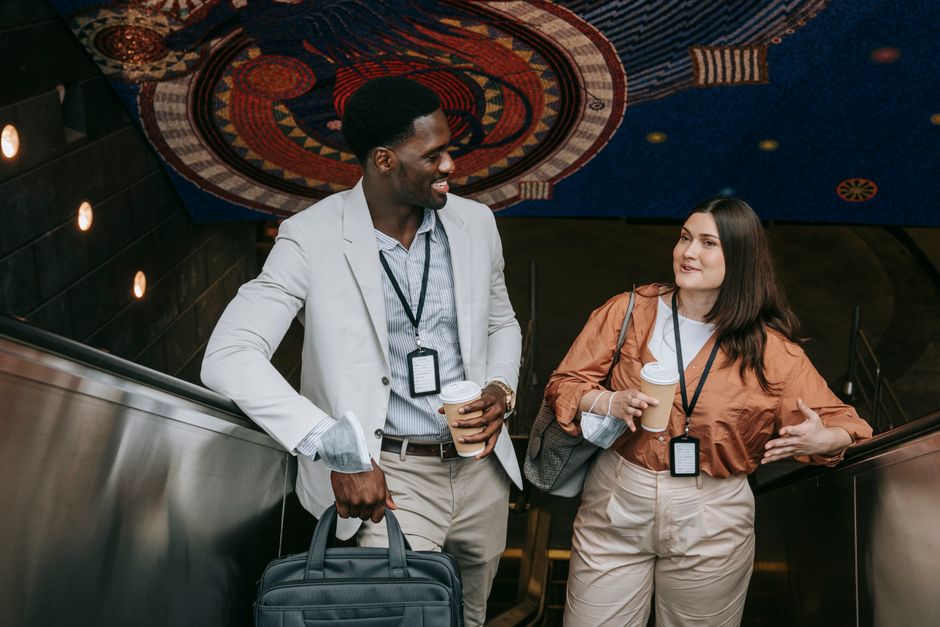 Diverse working professionals commuting in a busy city, dressed in various stylish and practical layers suitable for changing urban weather.