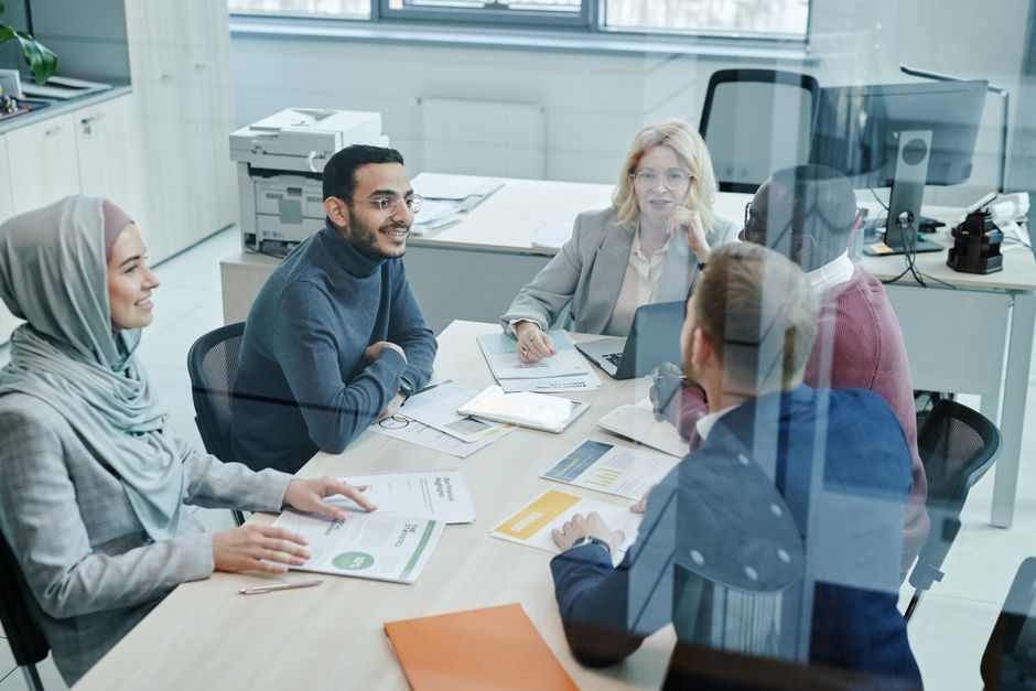 Diverse business professionals engaging in a meeting in a bustling European or South American market, representing the importance of local context.