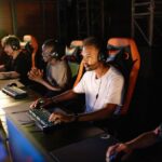 Four diverse gamers, two men and two women, smiling while on a private Discord call, each with a headset on, indicating social gaming without public chat.