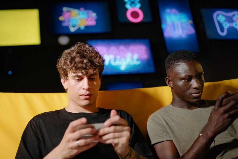 Competitive mobile esports team focused on their smartphones during a tournament, showcasing the intensity of mobile gaming.