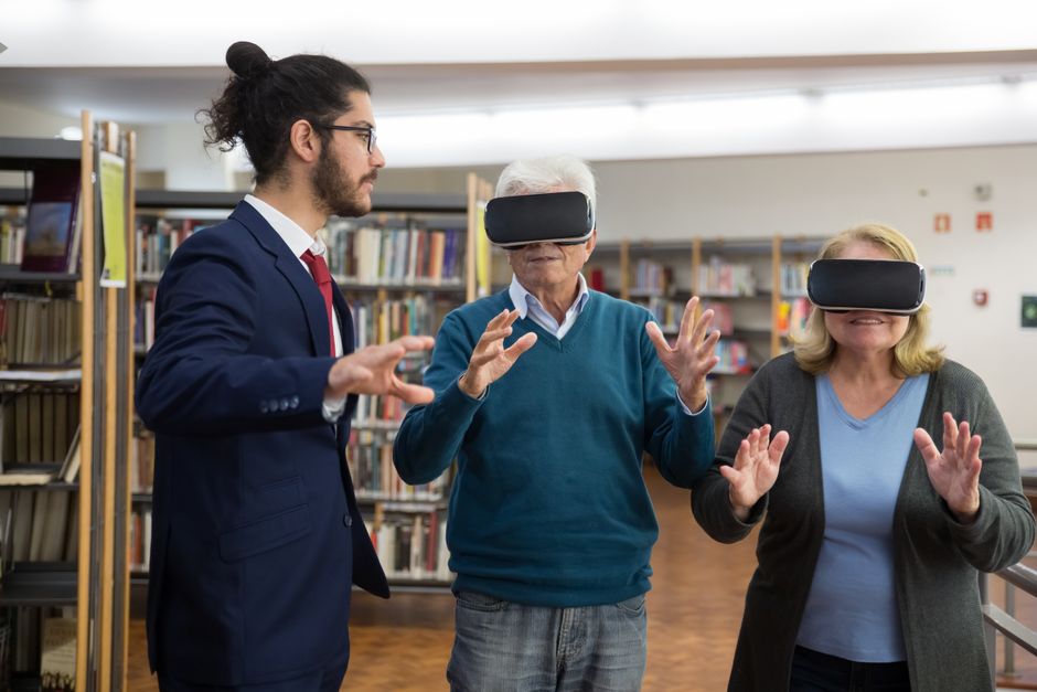 A diverse group of friends or family members interacting with a holographic display, which projects a virtual neighborhood with AI-generated insights about schools, amenities, and commute times.