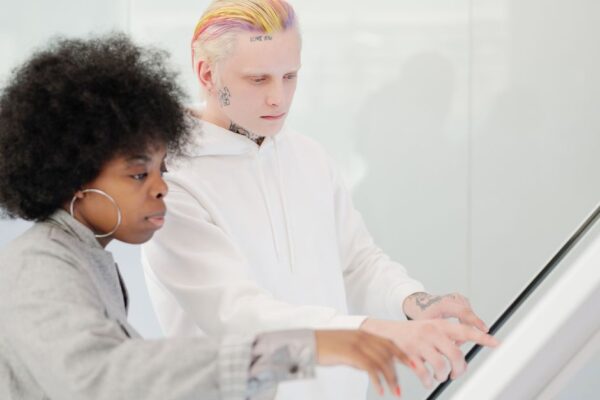 People from various backgrounds engaging with AI-powered smart home devices and collaborative work tools, depicting the practical future of AI.
