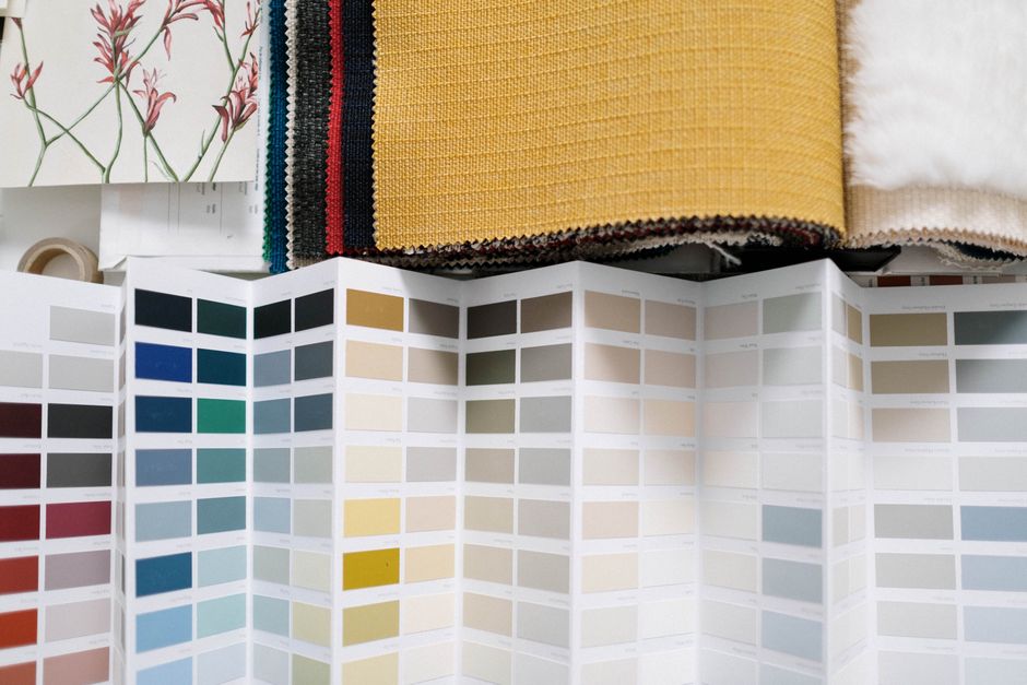A display of various fabric swatches, including linen, lightweight cotton, and Tencel, ideal for warm, humid climates.