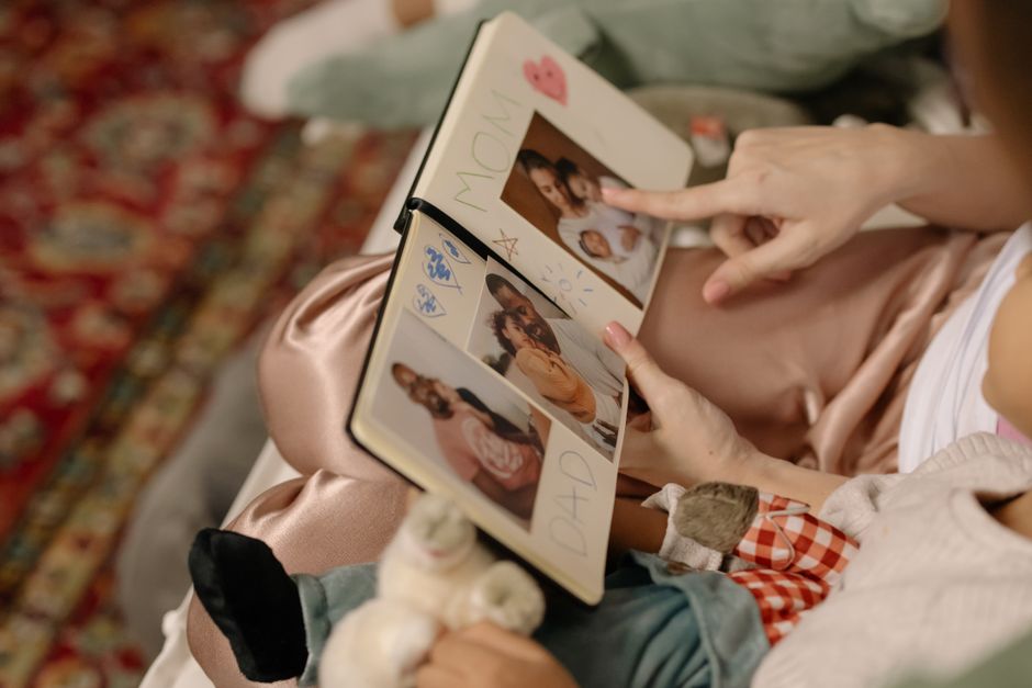A family looking at a tablet together, sharing photos that are presumably stored in a cloud service.