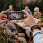 A family looking at photos on a smartphone, representing precious digital memories at risk of loss without backup.
