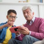 A family happily playing a colorful cloud game together on a tablet, demonstrating ease of access.