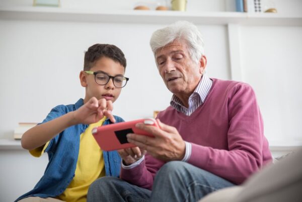 A family happily playing a colorful cloud game together on a tablet, demonstrating ease of access.