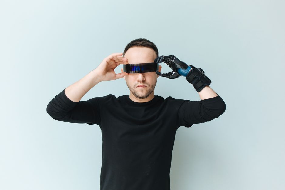 A person with an elegant, minimalist outfit wearing slim, dark smart glasses, demonstrating how wearable tech blends into high fashion.