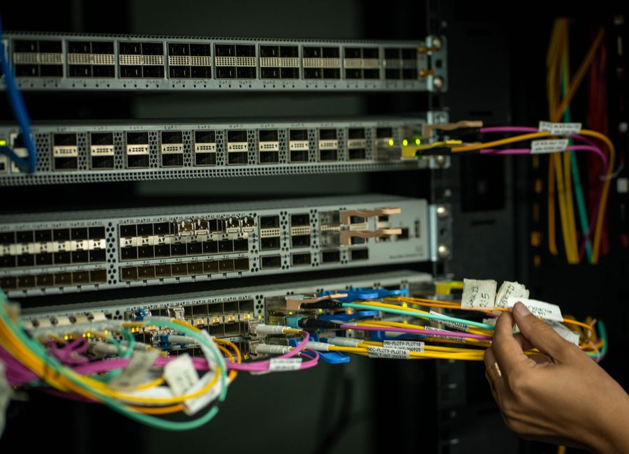 Bright fiber optic cables running through a modern city, symbolizing high-speed internet infrastructure.
