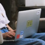 A freelancer focused on a laptop screen, with subtle glowing AI interface elements around, representing efficiency.