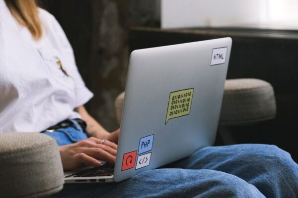 A freelancer focused on a laptop screen, with subtle glowing AI interface elements around, representing efficiency.
