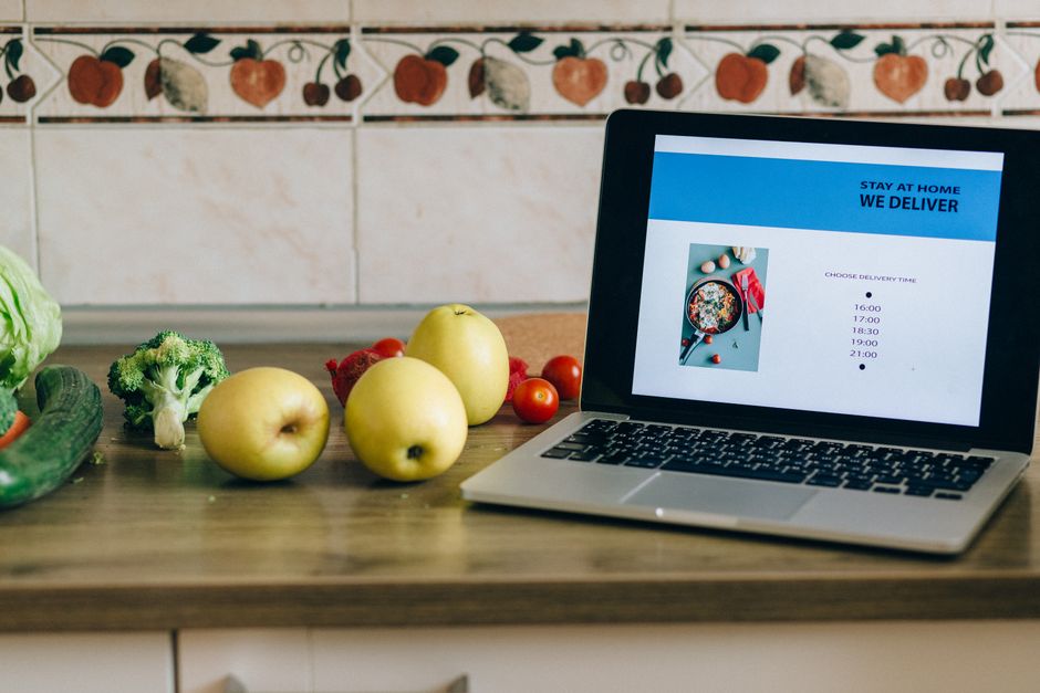 A vibrant display of fresh, colorful fruits and vegetables (berries, leafy greens, citrus) neatly arranged on a clean kitchen counter, symbolizing healthy eating options.
