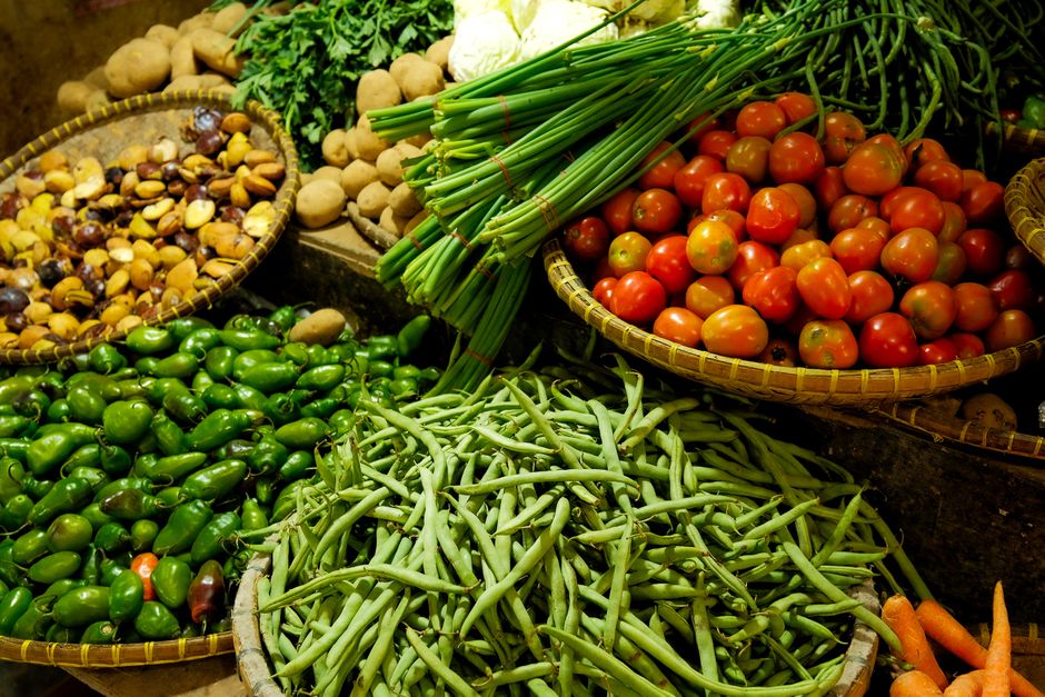 A colorful array of fresh fruits and vegetables neatly arranged at a local market stall.