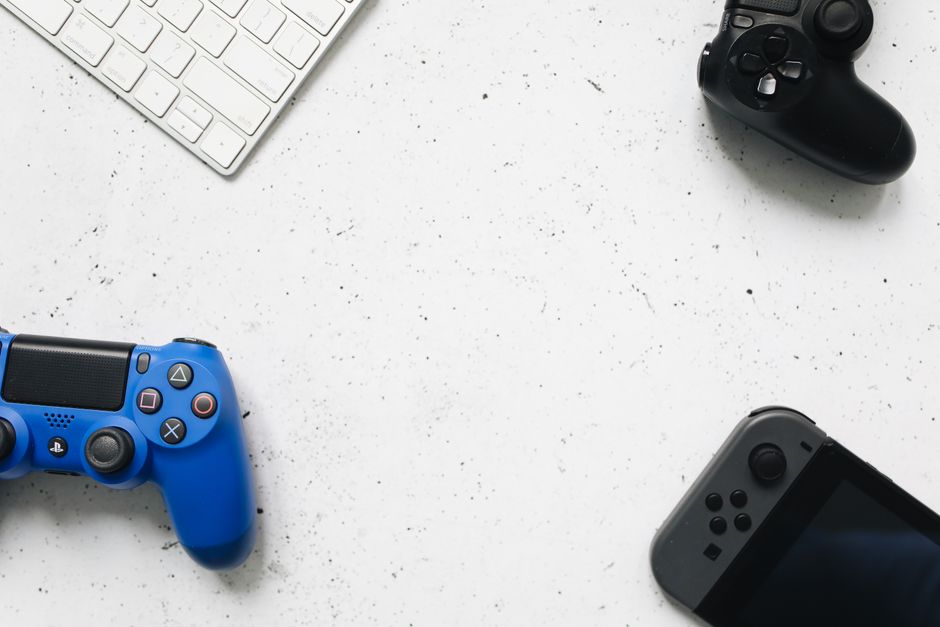 Three different gaming controllers – an Xbox, PlayStation, and a mobile-specific gamepad – displayed side-by-side to show variety.