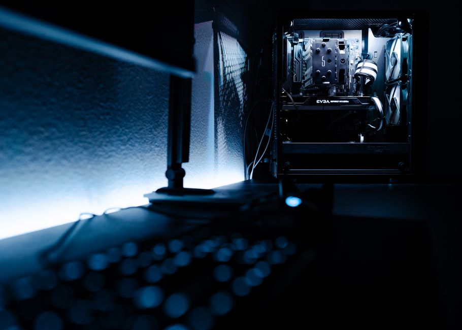 Close-up of a gaming PC setup with a monitor displaying a game, keyboard, and mouse.