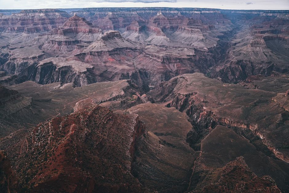 An aerial view of the vast Grand Canyon, showcasing the dramatic natural landscapes of North America.