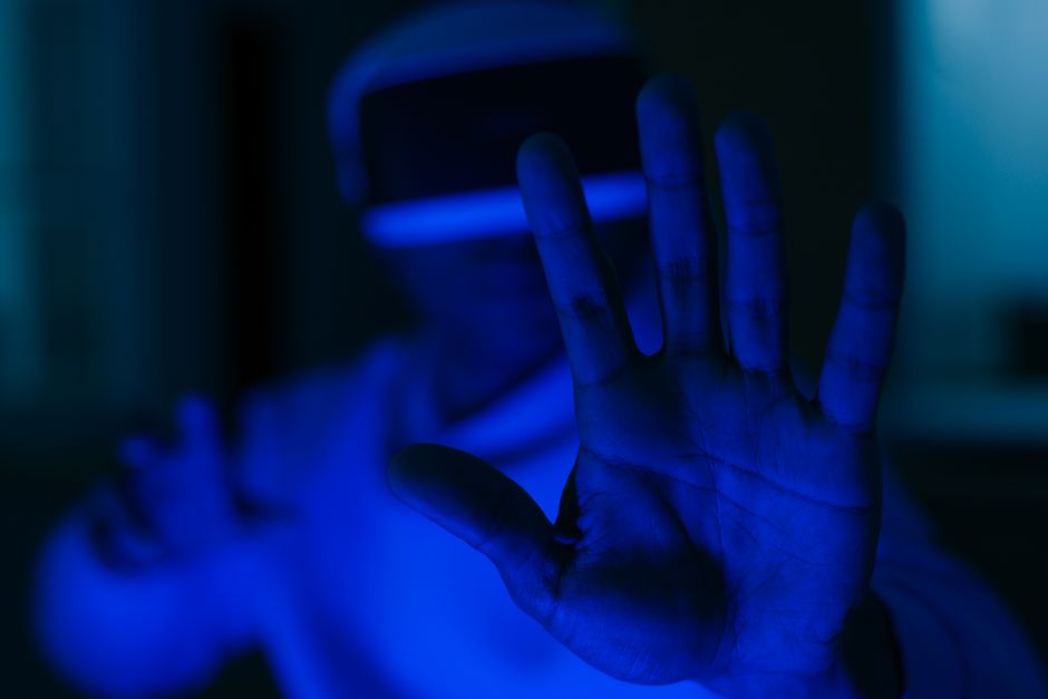 A close-up of a hand hovering over a futuristic holographic calendar display, showing various appointments and AI-generated insights.