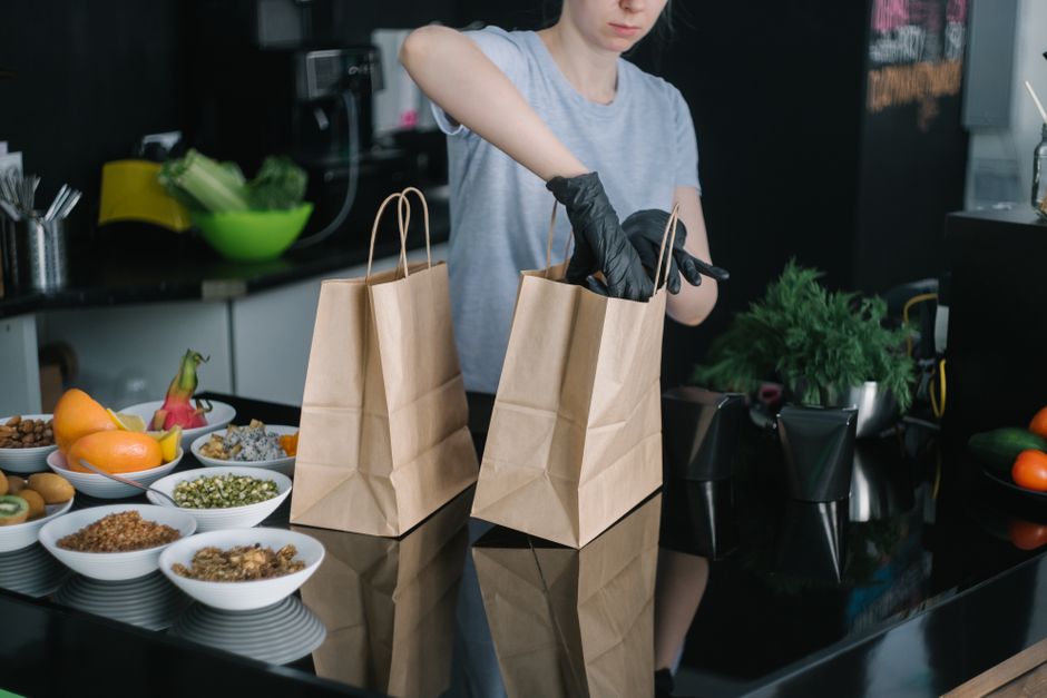 Various containers of prepped healthy meals like chopped vegetables, grilled chicken, and salads in a modern kitchen.