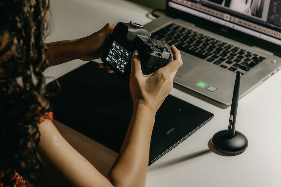 A person with glasses, likely an editor, thoughtfully reviewing content on a laptop, emphasizing human judgment in the content creation process.