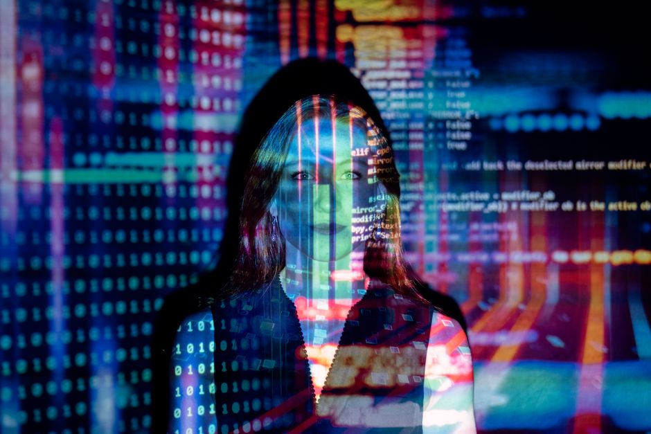 A split image showing a human hand writing on paper on one side and lines of AI code on the other, representing the human-AI content divide.