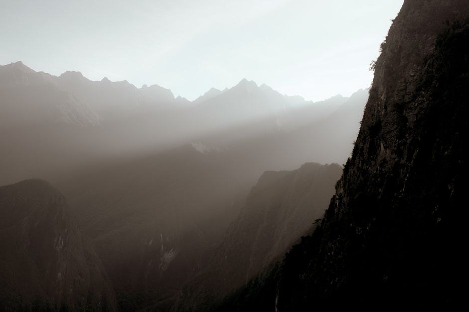 The ancient Inca citadel of Machu Picchu shrouded in a soft morning mist, with no visible crowds, highlighting the serenity of shoulder season travel.