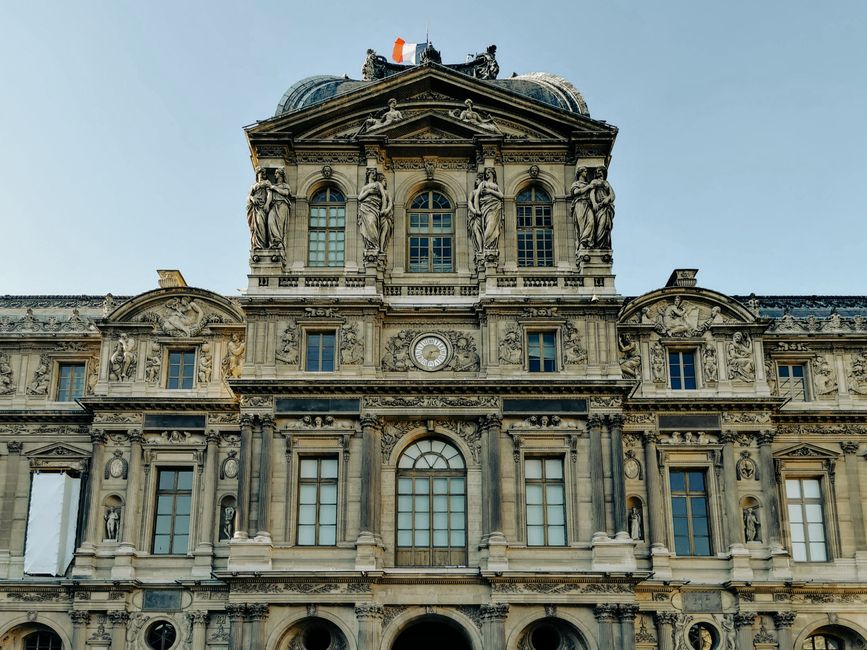 The distinctive modern facade of a museum building, with a clear sky and architectural details visible.