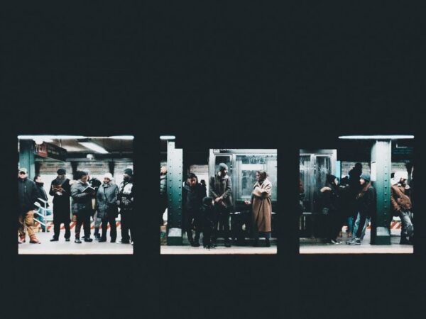 A bustling New York City subway platform with a train arriving, commuters waiting, illustrating efficient public transit.