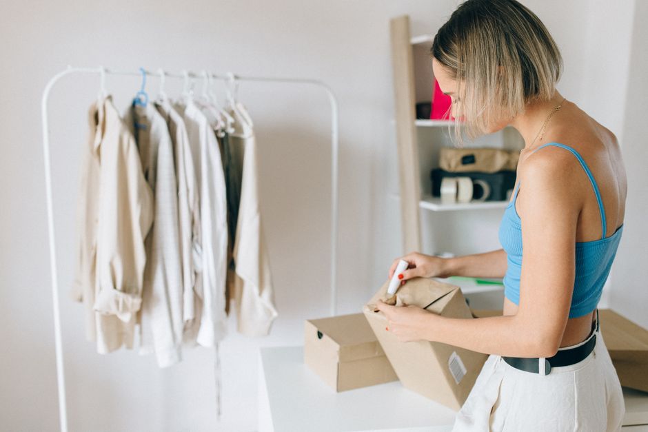 An interior shot of an online consignment shop, showcasing neatly arranged racks of stylish pre-owned clothing.