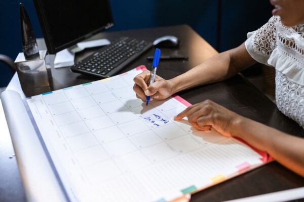 A neatly organized desk with a planner, laptop, and coffee mug, symbolizing effective Sunday planning.