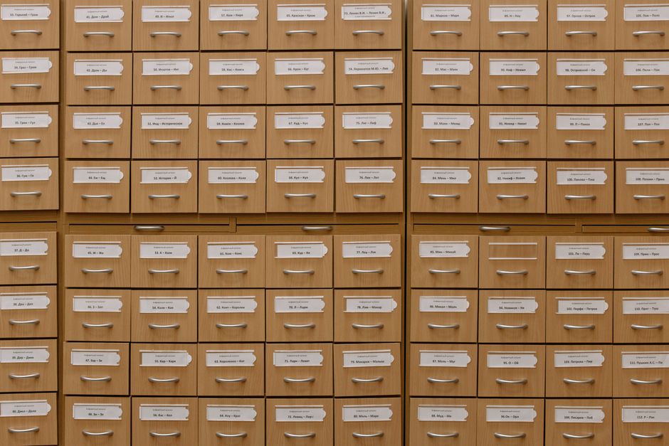 A neat, open filing cabinet with clearly labeled folders in different colors, demonstrating an organized system.