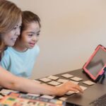 A parent and child browsing safe online games for kids on a tablet, looking at options.
