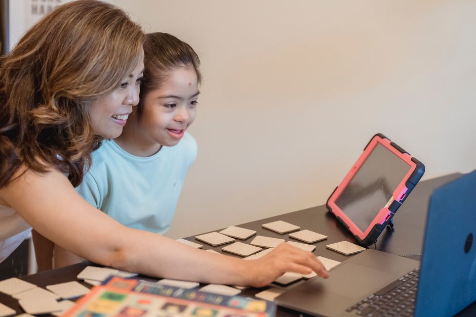 A parent and child browsing safe online games for kids on a tablet, looking at options.