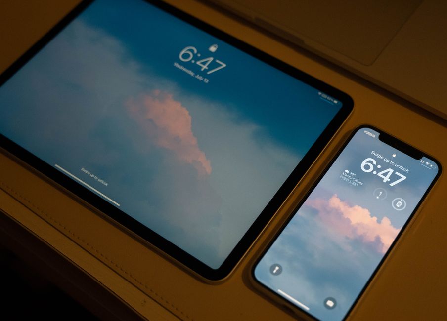 Three different digital devices (smartphone, tablet, laptop) displaying login screens with a stylized passkey icon connecting them, showing seamless synchronization.