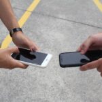 Three phones side-by-side displaying iCloud, Google Photos, and OneDrive apps, representing choice in cloud storage.